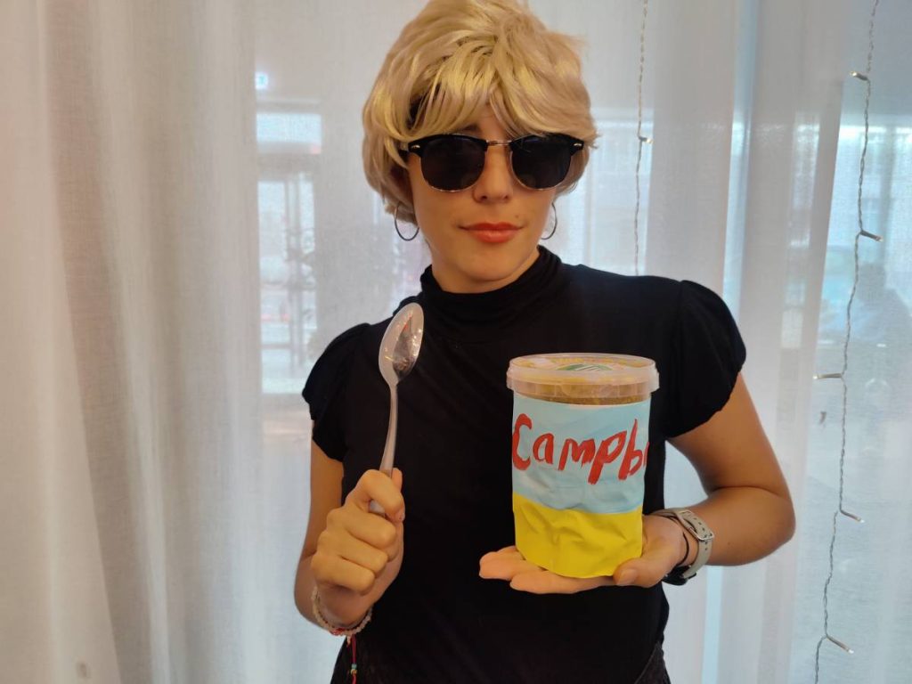 halloween costume a woman wearing sunglasses and holding a spoon and a container of soup
