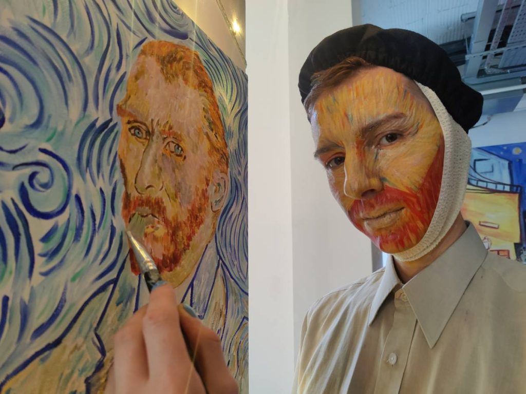 a man painting a picture in a Halloween Costume