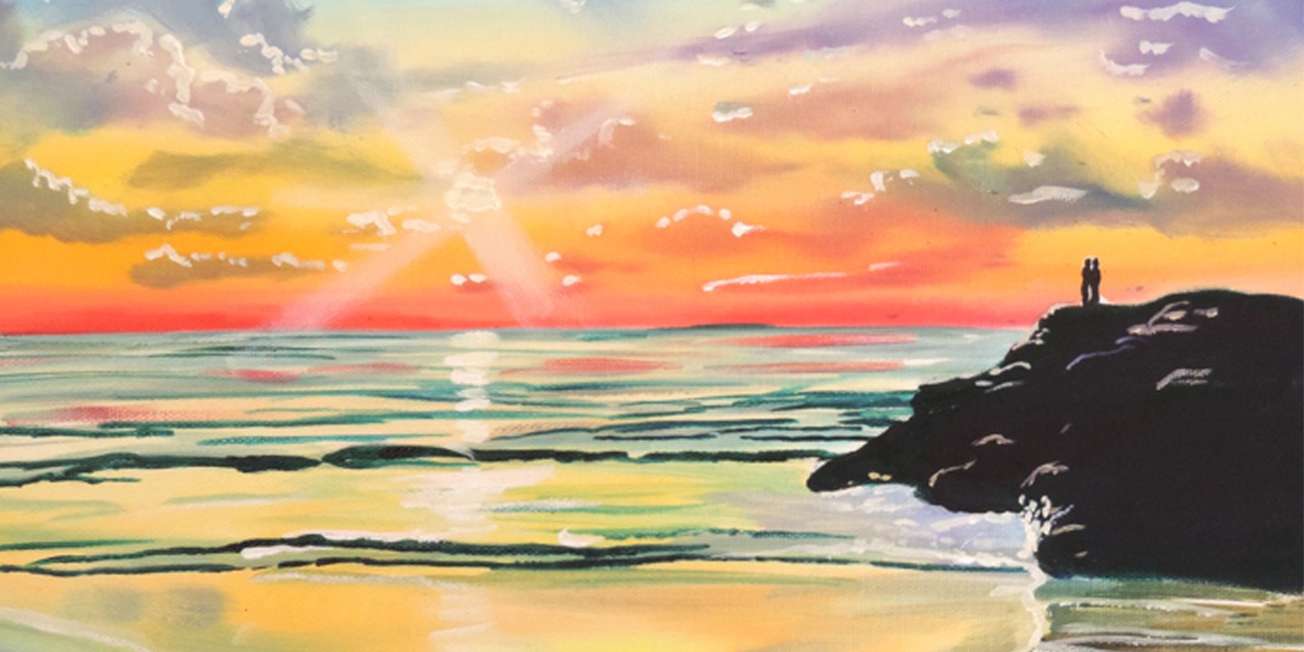 couple watching the sunset on some big rocks