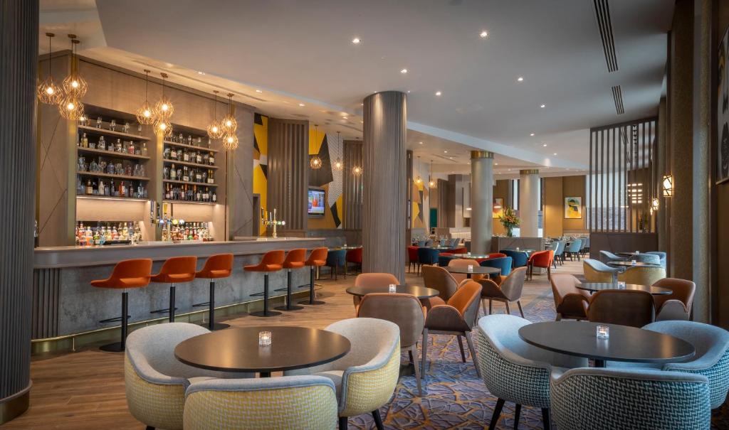 a room with tables and chairs maldron hotel manchester