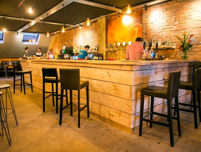 a bar with people sitting at the counter seven bro7hers ancoats