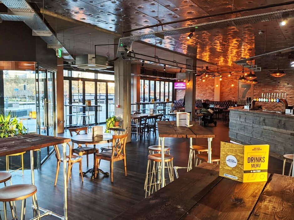 a room with tables and chairs seven bro7hers beerhouse