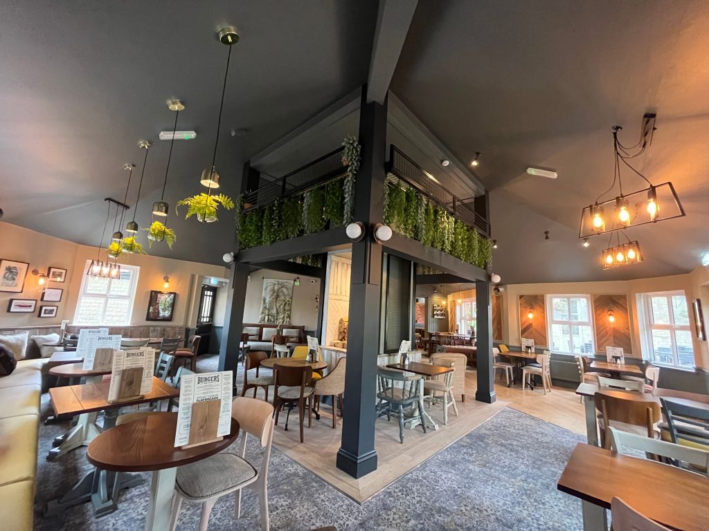 a room with tables and chairs the spring inn roachdale